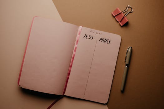 Open notebook for setting New Year resolutions with a pen on a brown background.